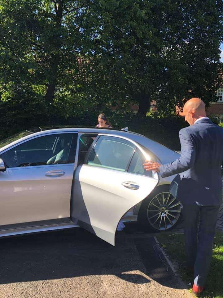 Chauffeur Mark Heaney helping a customer in to our Mercedes s class